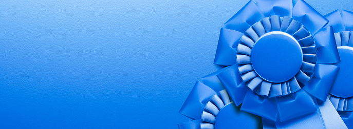Three blue ribbons on a panoramic blue background.