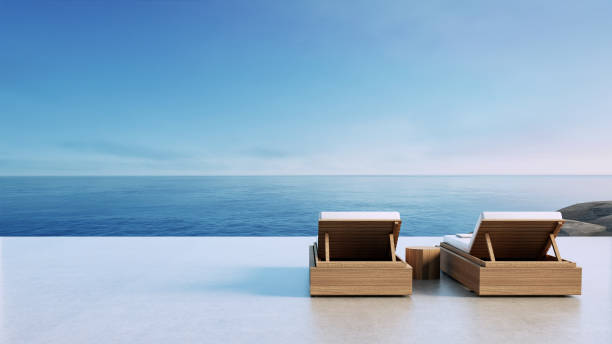 Luxury beach Lounge chair on the balcony overlooking 

the sea view - 3D rendering