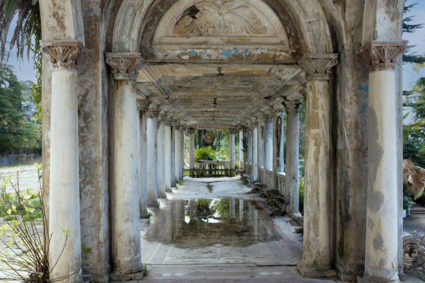 Crumbling pavilion with marble colonnade of abandoned railway platform Gagrypsh in Gagra, Abkhazia. The crumbling legacy of Soviet Stalinist architecture