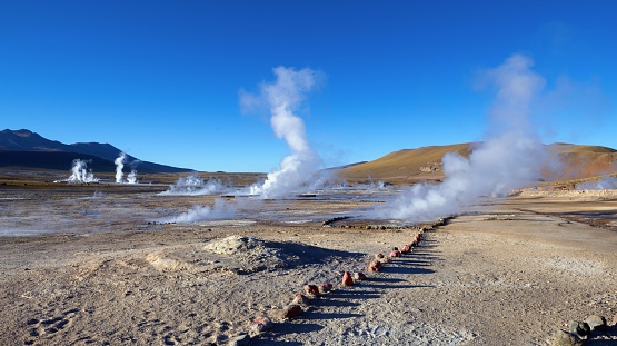 San Pedro de Atacama, Chile, December 4, 2018: View of El Tatio geyser field in the Andes Mountains of northern Chile at dawn. El Tatio is a volcanic and geyser area in the northern part of Chile, at an altitude of about 4,300 m. The geysers spew steam just in the morning until sunrise. As soon as it dawns, the geysers are silent.