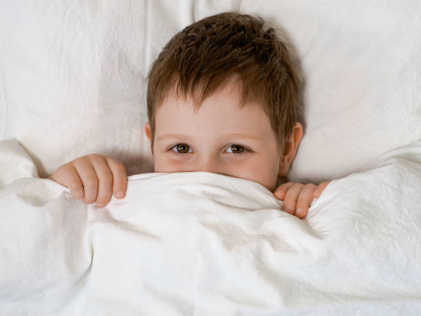 istock Young boy in bed before going to sleep 1504194417