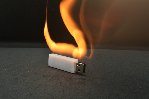thumb drive on fire, black background