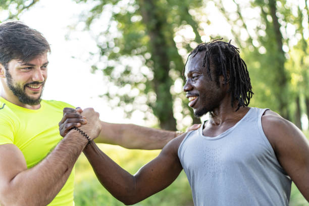 istock Two joggers greeting each other with a high five gesture during summer workout in nature 1504210909