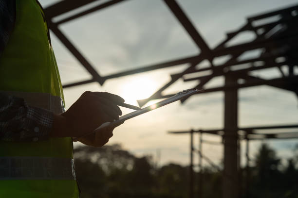 istock inspector or engineer is inspecting construction and quality assurance new house using a checklist. Engineers or architects or contactor work to build the house before handing it over to the homeowner 1504212274
