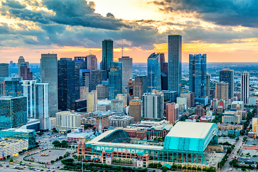 Houston, United States - April 13, 2023:  Minute Maid Park, the home of Major League Baseball's Houston Astros located in downtown Houston, Texas shot from an altitude of about 500 feet at sunset.