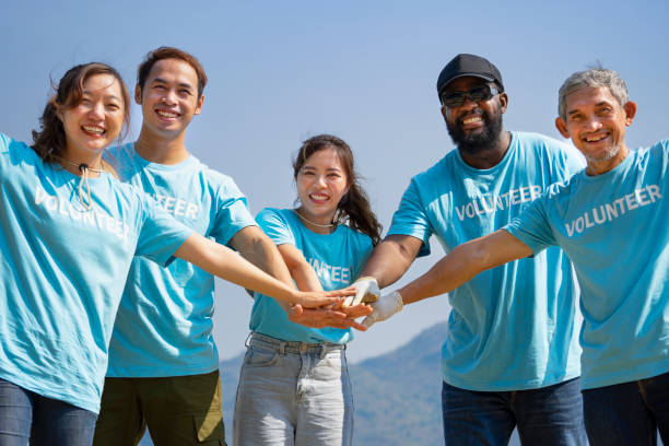 istock A group of diverse ethnicity volunteers stack their hands on top of each other 1504224640