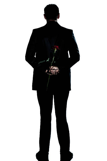 istock silhouette man back  full length holding a rose flower 150424328