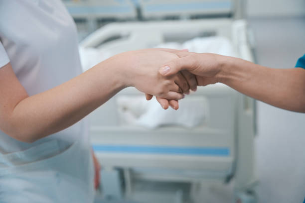 istock Physicians shaking hands to each other at clinic 1504251192