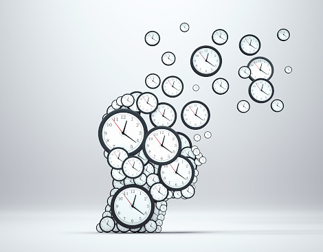 Planning time business concept or wasting minutes as a group of clocks shaped as a human head .  This is a 3d render illustration