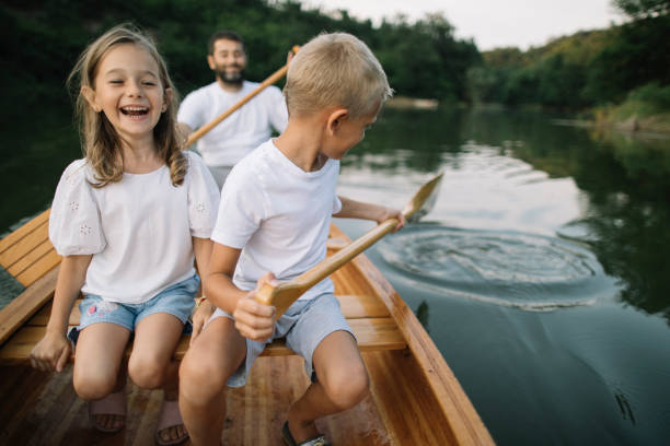 istock Kids enjoy nature by canoeing with their father 1504267457