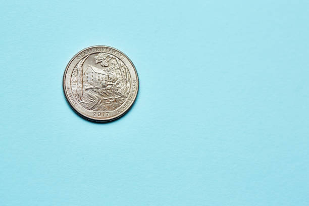 istock US quarter dollar coin on a blue background with copy space 1504270593