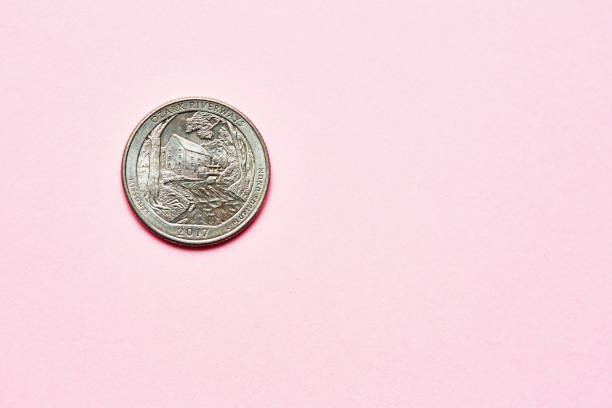 US quarter dollar coin on a pink background with copy space