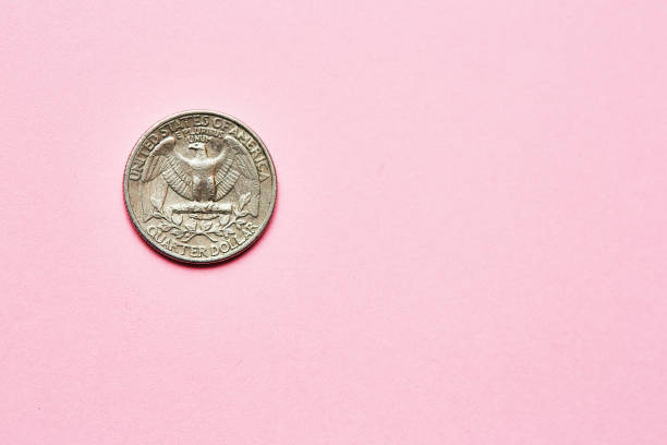 istock US quarter dollar coin on a pink background with copy space 1504271893