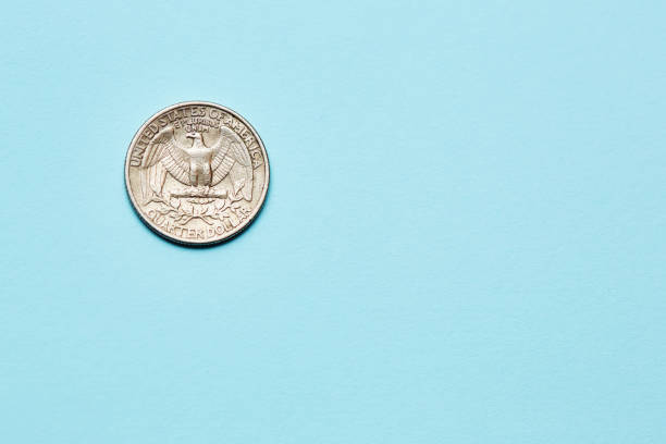 istock US quarter dollar coin on a blue background with copy space 1504271906