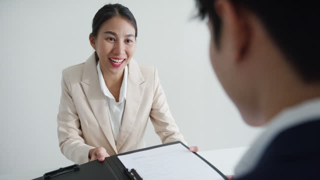 Young Asian woman pass job interview sit in front of HR manager at office. Human resource, Recruitment agency.