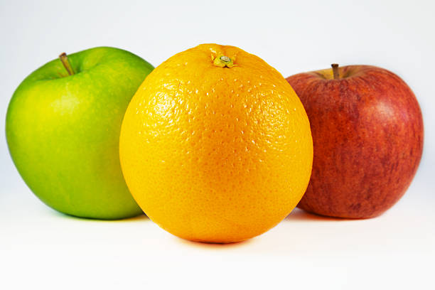 Orange And Two Apples stock photo