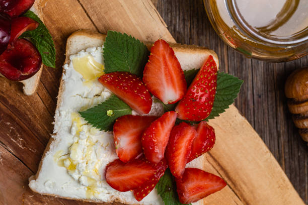 istock Sandwiches with cream cheese, honey and berries. Dessert 1504320322
