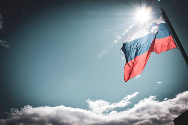The national flag of Slovenia features three equal horizontal bands of white (top), blue, and red, with the coat of arms of Slovenia located in the upper hoist side of the flag centred in the white and blue bands.
