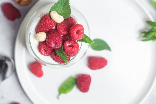 Granola with yogurt and raspberries in a glass