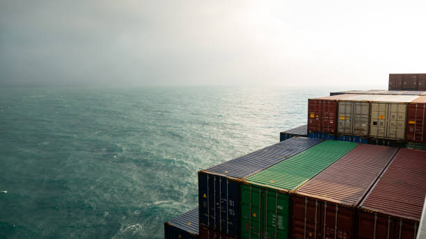istock Different color containers loaded on ultra large container vessel 1504332528