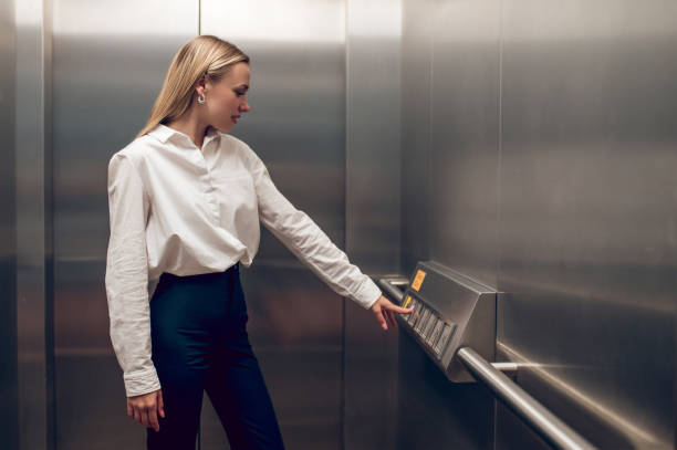 istock Slim young blonde woman in the elevator 1504354730