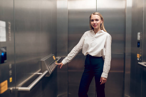 istock Slim young blonde woman in the elevator 1504354738