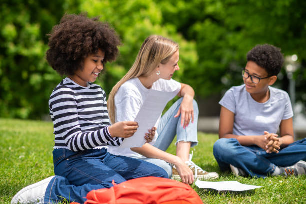 istock Blonde girl helping kids with home work 1504355260
