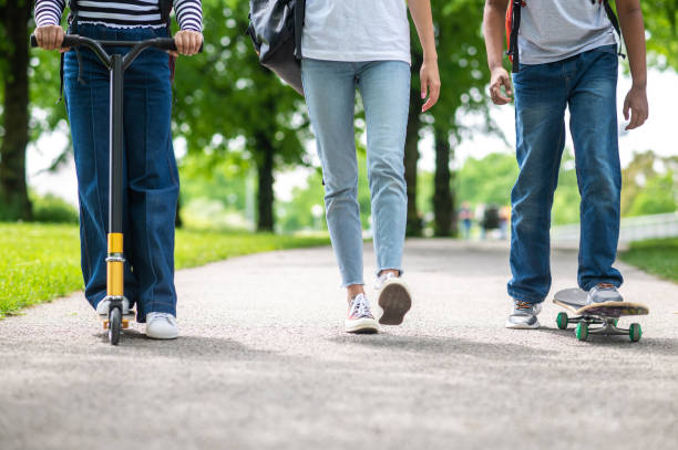 istock Cute kids on a longboards in the park 1504355823