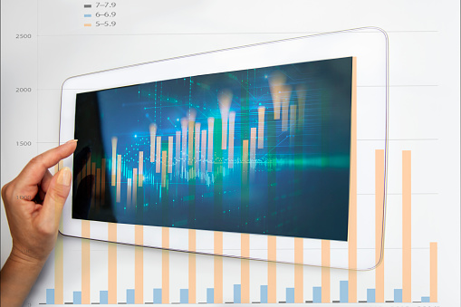 Double exposure of abstract creative financial diagram with female hand typing on digital tablet computer keyboard. Technology, banking and accounting concept. Copy space on white