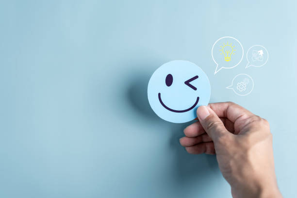 istock Hand holding smile face emoticon paper cut with light bulb smart idea, creativity and solution concept. 1504387350