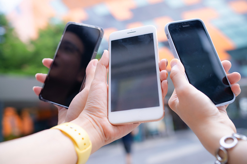 Crop group of friend's hand and smartphone using smartphone connecting together for paying  cost of food and retail shopping.