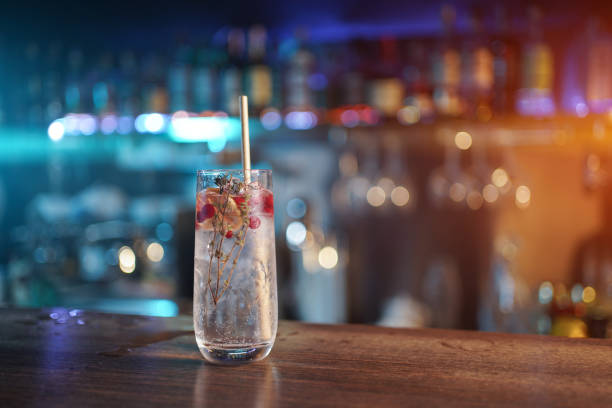 istock modern gin tonic cocktail with ice, straw and red berries on bar counter 1504394726
