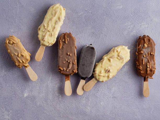 gelati assortiti su stecco sullo sfondo, stick gelato, gelateria, ghiacciolo al cioccolato - chocolate almond foods and drinks white chocolate foto e immagini stock