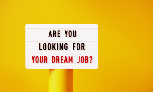 Are you looking for your dream job written white lightbox on yellow podium before yellow background. Horizontal composition with copy space.