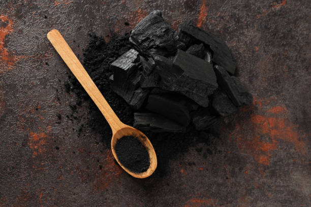 istock Natural wood charcoal and spoon on textured background 1504419586