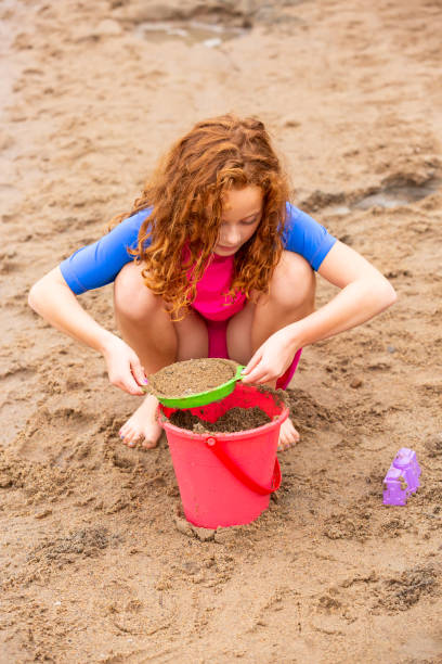 istock Curly Haired Redhead Girl At The Beach 1504423952
