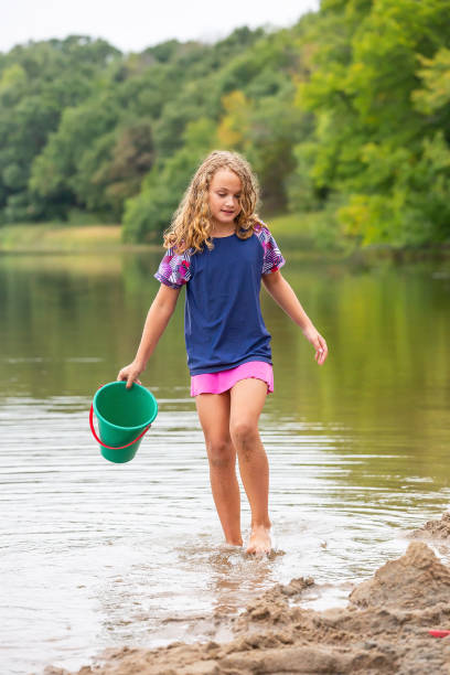 istock Girl Walking Along Water At Beach 1504423958