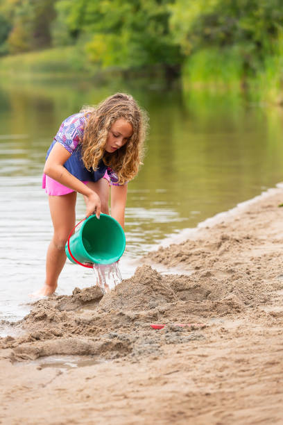 istock Girl Building A Sand Structure at The Beach 1504424481