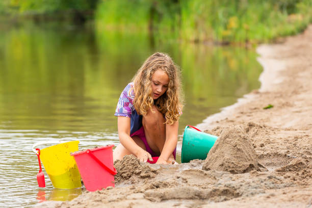 istock Girl Building A Sand Structure at The Beach 1504425042