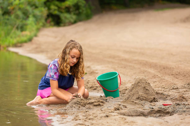 istock Girl Building A Sand Structure at The Beach 1504425046