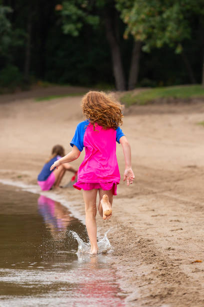 istock Girl Running Along Beach on Summer Day 1504426146