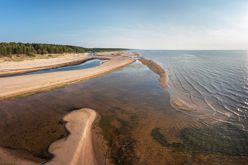 The estuary of river Lilaste in Baltic sea. Photographed on a summer evening from drone