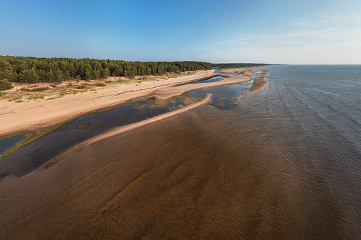 The estuary of river Lilaste in Baltic sea. Photographed on a summer evening from drone