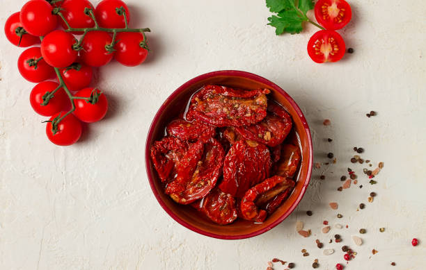 istock dried tomatoes, in a bowl, top view, on a white background, 1504443870