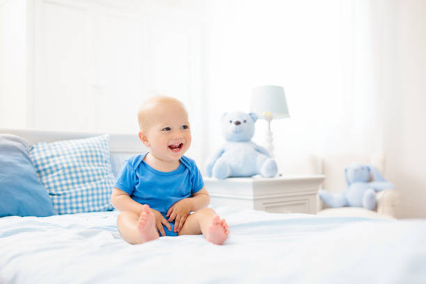 istock Little baby boy on white bed 1504447932