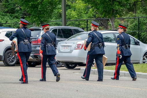 Calgary, Alberta, Canada. Jun 27, 2023. Calgary women police officers wearing uniforms walking on the street during summer.