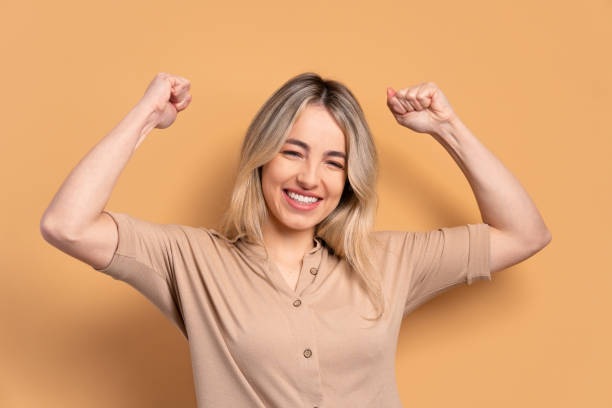 istock woman flexing arms in studio shot 1504472854