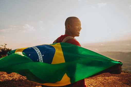 Man holding the flag of Brazil