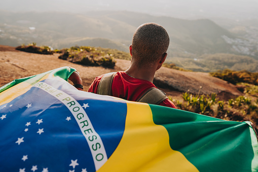 Man holding the flag of Brazil