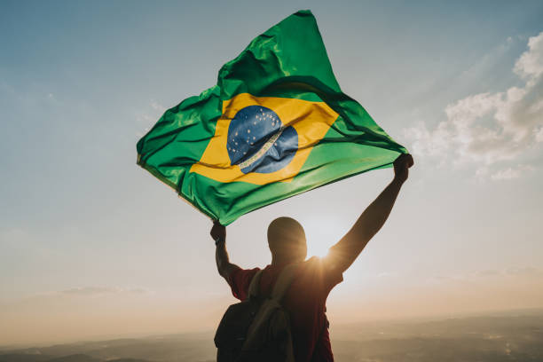 man holding the flag of brazil - independence imagens e fotografias de stock